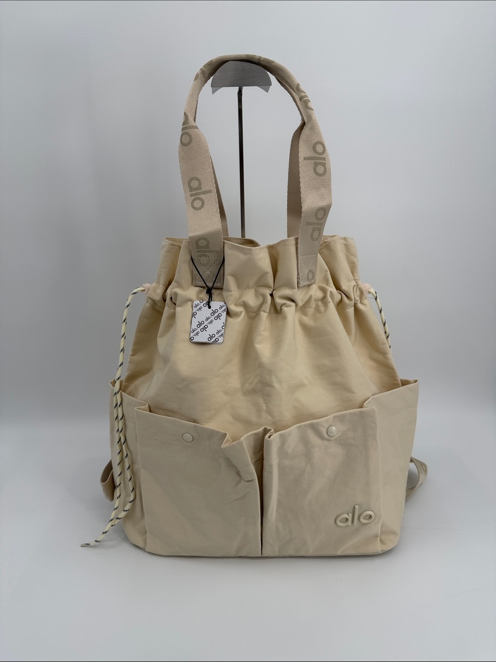 ALO Yoga Cream Drawstring Tote Backpack with Front Pockets Convertible Tote Bag